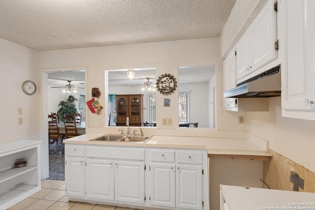 111 Casa Blanca, Del Rio, TX 78840 - kitchen with a sink, under cabinet range hood, ceiling fan, white cabinetry, and light countertops