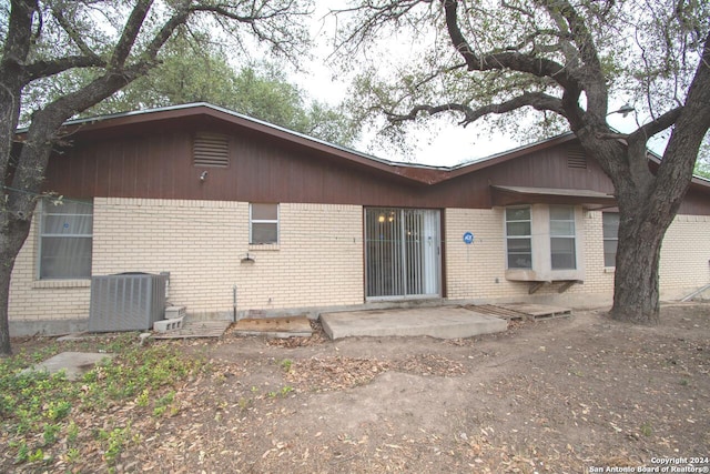 rear view of property featuring central air condition unit and a patio area