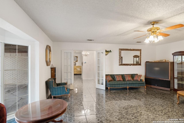 111 Casa Blanca, Del Rio, TX 78840 - living area featuring a textured ceiling, a chandelier, ceiling fan, baseboards, and french doors