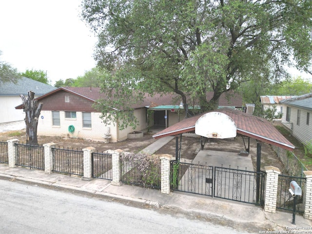 111 Casa Blanca, Del Rio, TX 78840 - view of front facade featuring a fenced front yard, brick siding, and a gate