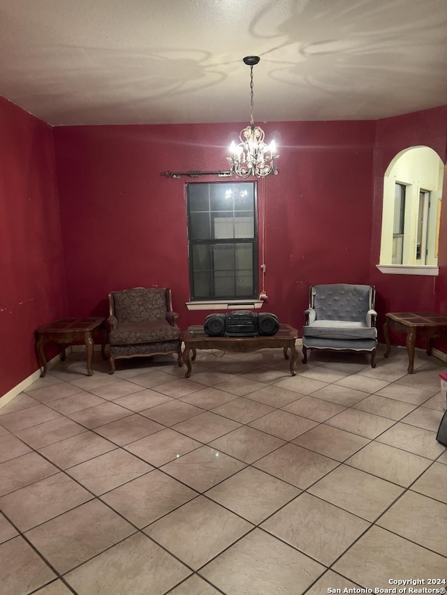 living area featuring tile patterned floors and a notable chandelier