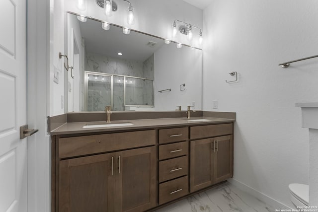 bathroom with a shower with shower door, toilet, and vanity