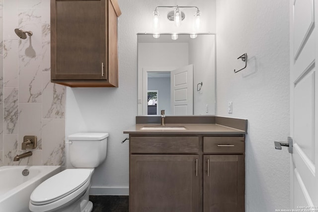 full bathroom featuring tiled shower / bath combo, vanity, and toilet