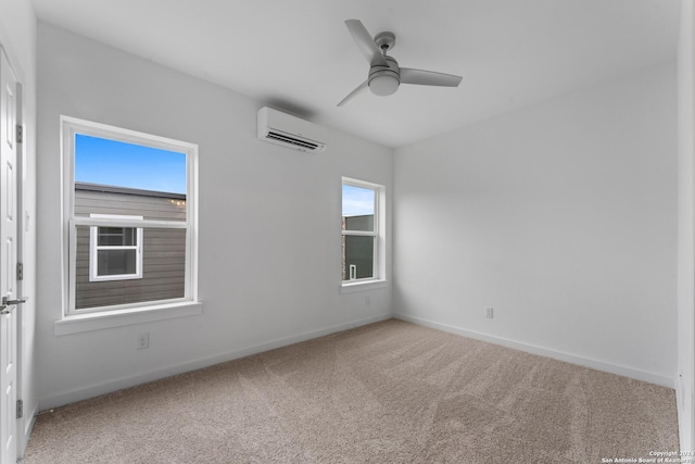 unfurnished room featuring ceiling fan, a wall mounted AC, carpet floors, and a healthy amount of sunlight