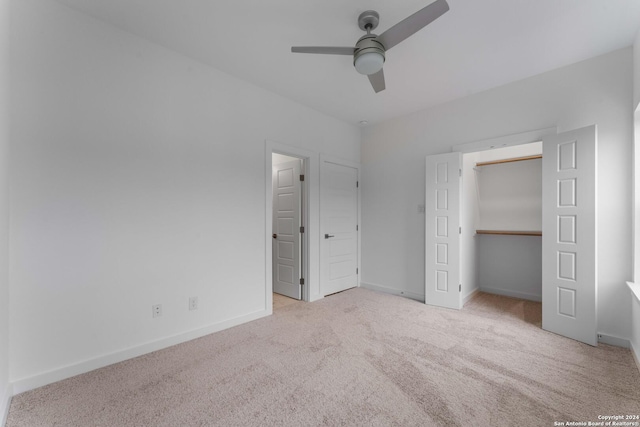 unfurnished bedroom featuring a closet, ceiling fan, and light carpet