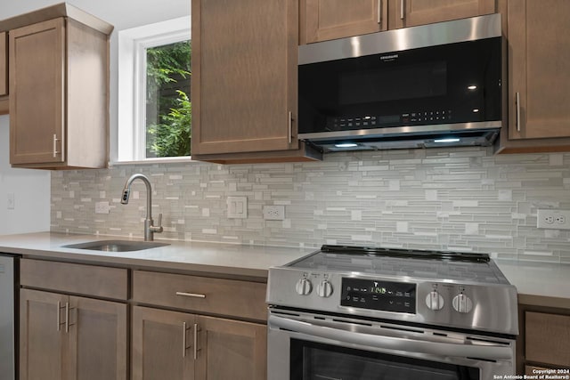 kitchen featuring sink, backsplash, and appliances with stainless steel finishes