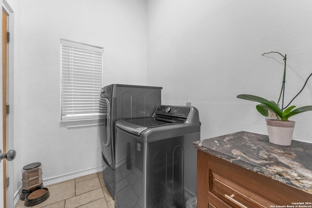 washroom with separate washer and dryer and light tile patterned flooring