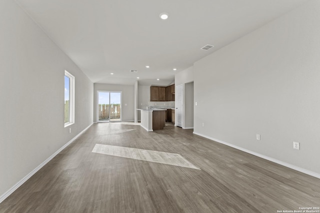 unfurnished living room with hardwood / wood-style flooring