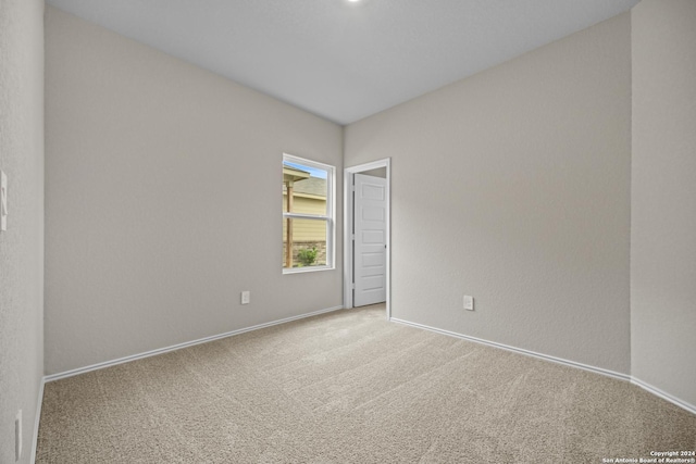 unfurnished room with light carpet