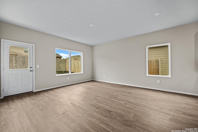 spare room featuring light wood-type flooring