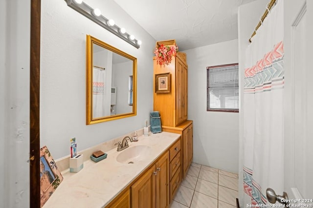 bathroom featuring tile patterned flooring and vanity