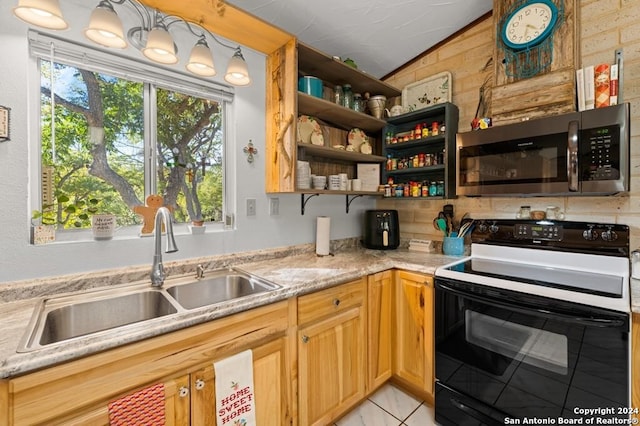 kitchen with electric range, lofted ceiling, and sink