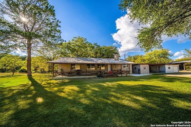 back of house featuring a lawn