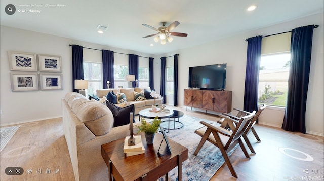 living room with ceiling fan and light hardwood / wood-style floors