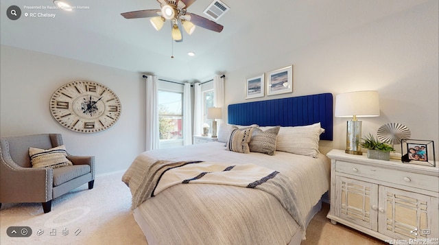 bedroom with light carpet, a ceiling fan, visible vents, and baseboards