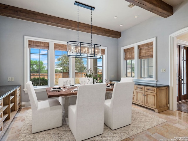 dining area featuring beamed ceiling and a notable chandelier