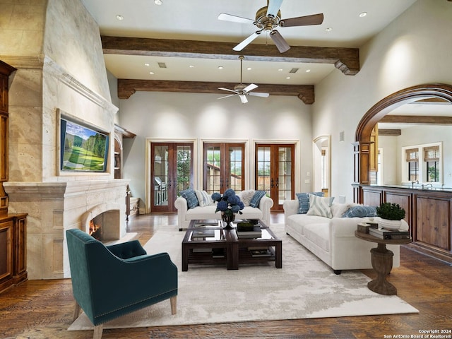 living room with hardwood / wood-style flooring, beam ceiling, and french doors