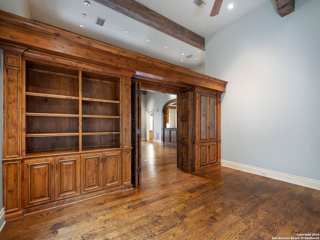 interior space with ceiling fan, beam ceiling, and dark wood-type flooring