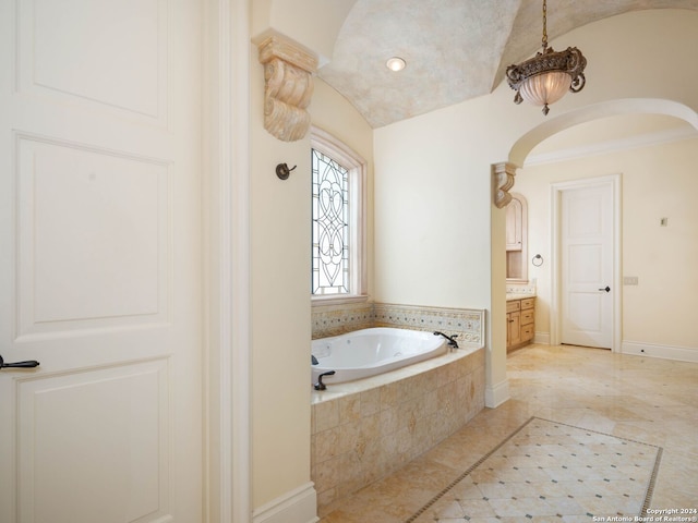 bathroom featuring vanity and tiled bath