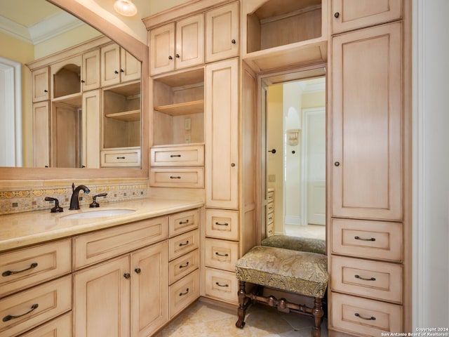 bathroom featuring crown molding, tile patterned flooring, and vanity