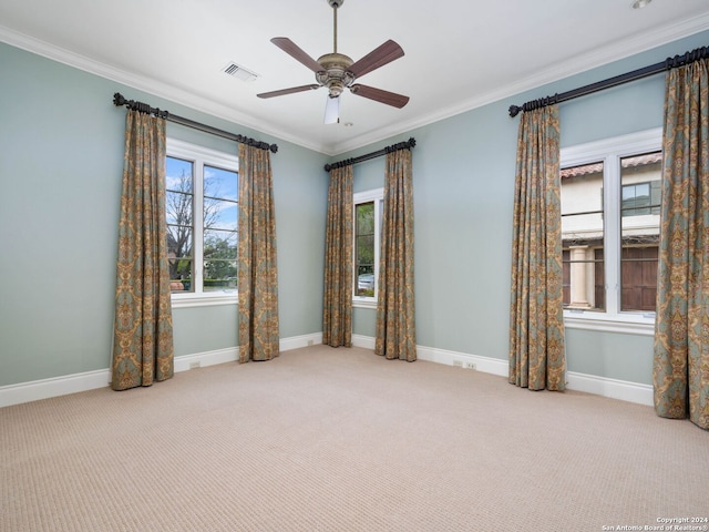 spare room with light colored carpet, ceiling fan, and ornamental molding