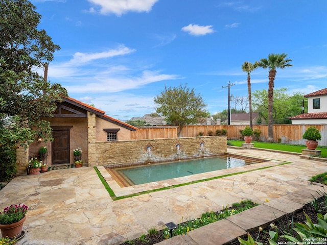 view of swimming pool with a patio