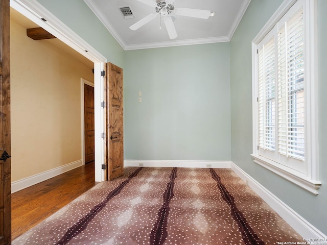 unfurnished bedroom with wood-type flooring, multiple windows, ornamental molding, and ceiling fan