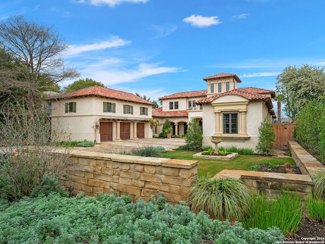 rear view of house featuring a garage