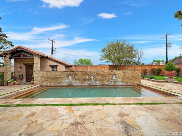 view of swimming pool with a patio