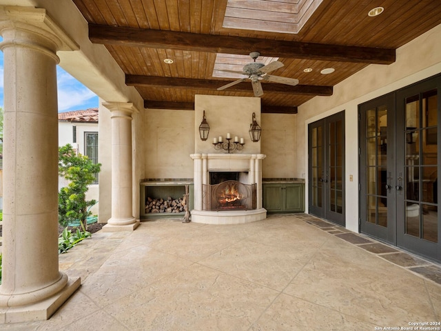 view of patio / terrace with ceiling fan, french doors, and an outdoor fireplace