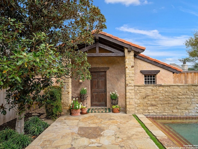 doorway to property with a patio area