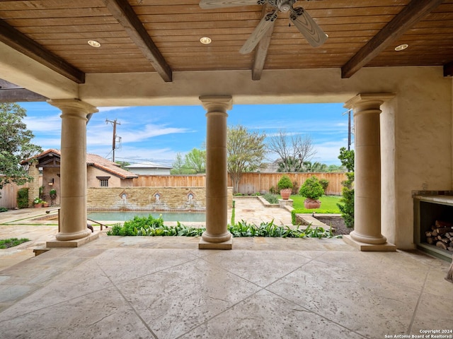 view of patio with exterior fireplace and ceiling fan