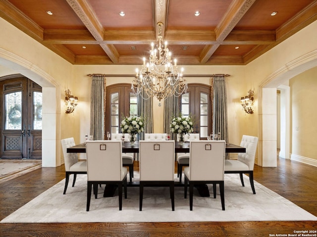 dining room with a healthy amount of sunlight, wood-type flooring, and coffered ceiling