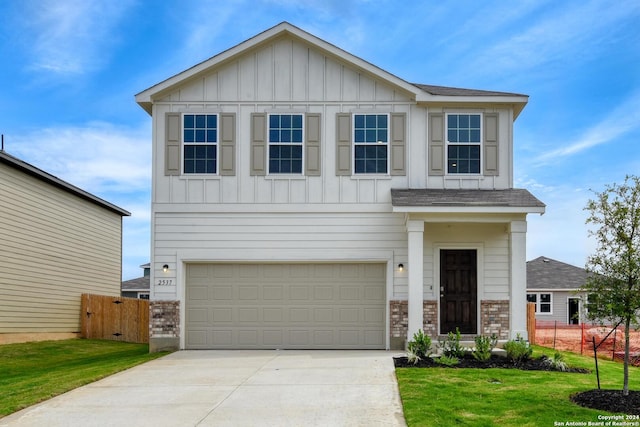 view of front of home featuring a garage and a front lawn