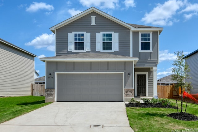 view of front property with a front lawn and a garage