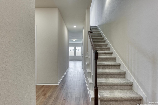 stairs with hardwood / wood-style floors