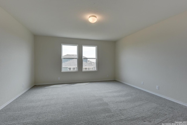 unfurnished room with light carpet