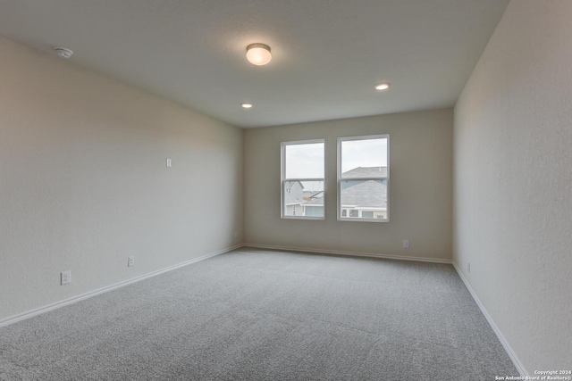 unfurnished room with light carpet