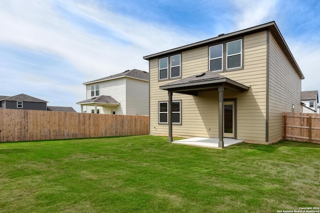 back of property featuring a patio and a lawn