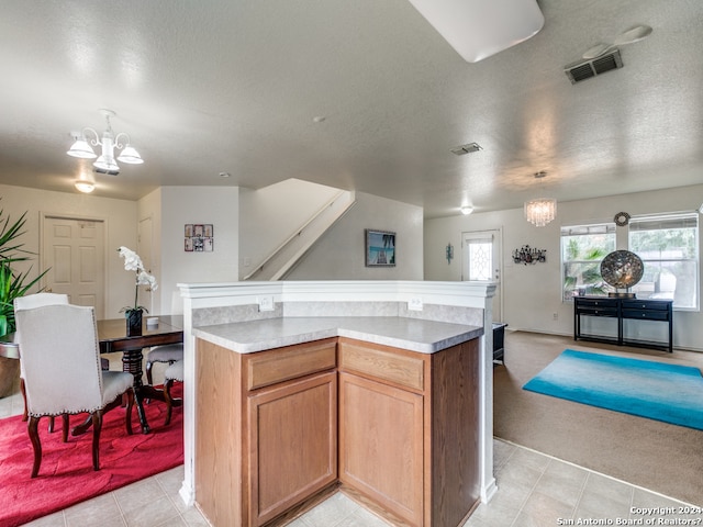 kitchen with pendant lighting, an inviting chandelier, and a kitchen island