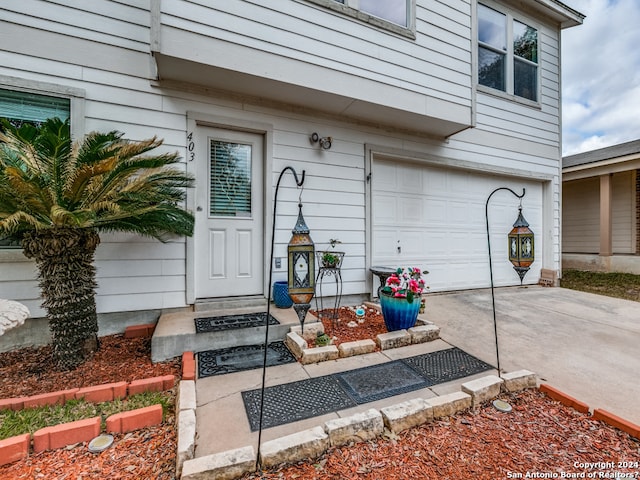 view of exterior entry with a garage