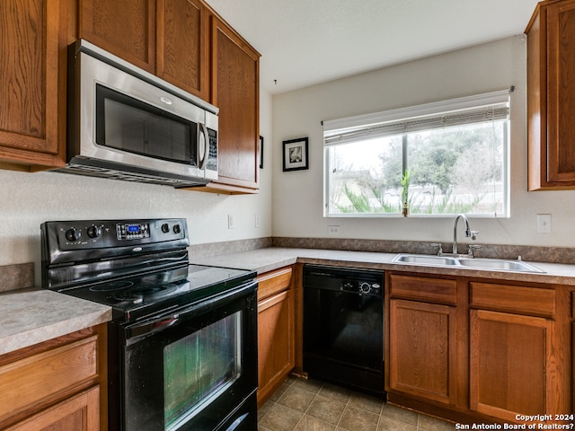 kitchen with sink and black appliances