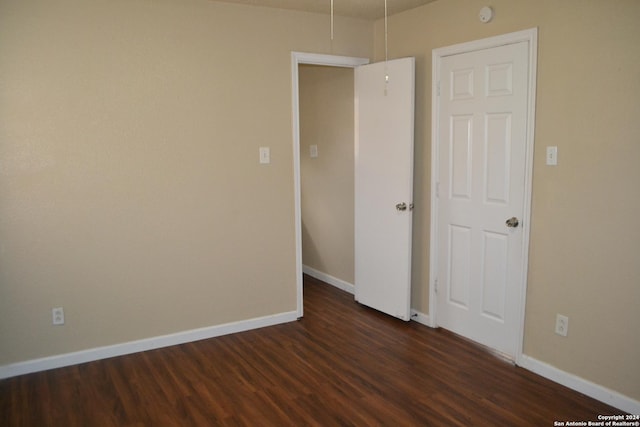 spare room featuring dark wood-type flooring