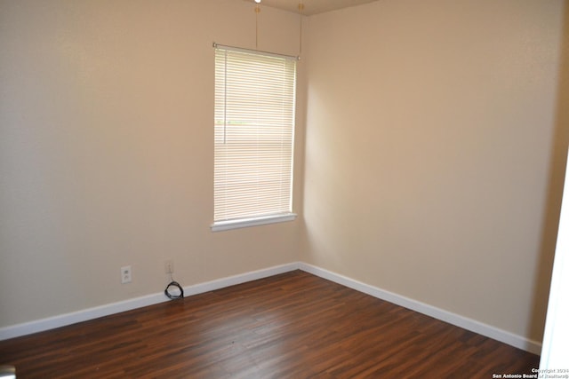 spare room featuring dark hardwood / wood-style flooring