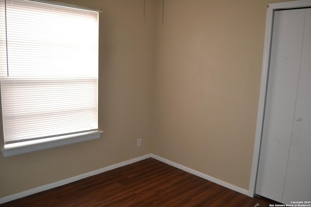 empty room with dark wood-type flooring