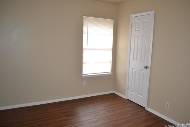 spare room featuring dark hardwood / wood-style floors