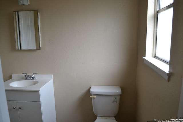 bathroom featuring vanity and toilet