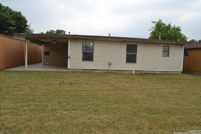 rear view of house with a yard and a patio area