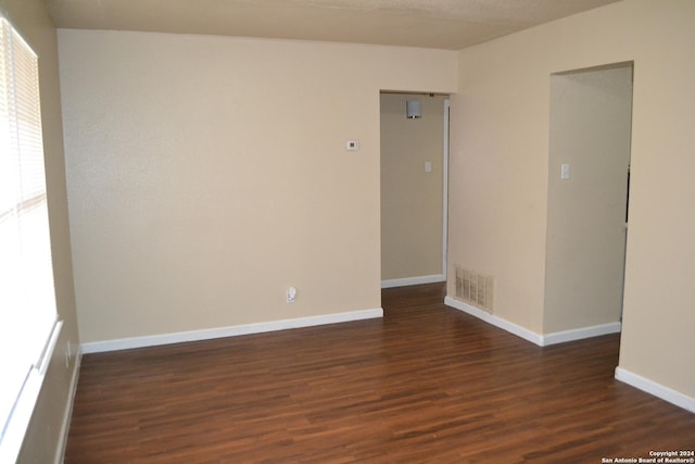 empty room featuring dark wood-type flooring