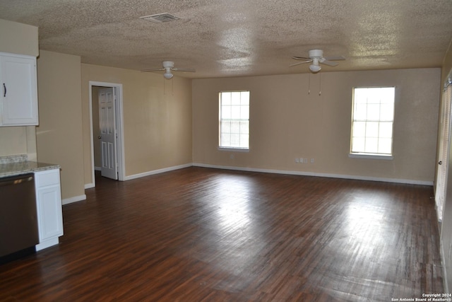 interior space featuring dark hardwood / wood-style floors, ceiling fan, and a textured ceiling